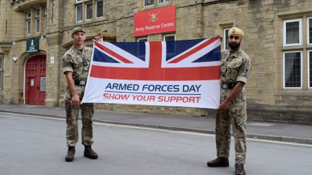 Two reserves from 4YORKS carry the Armed Forces Week flag