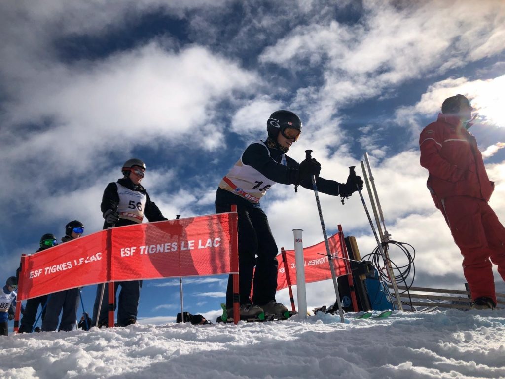 Skiers getting ready to descend a snowy mountain