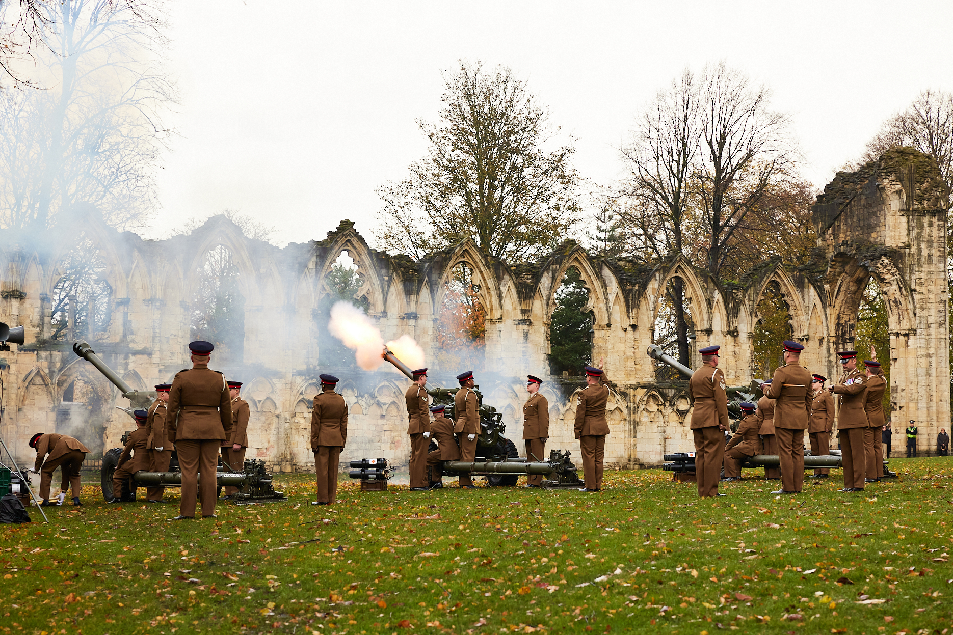 soldiers in the act of firing the gun carriages