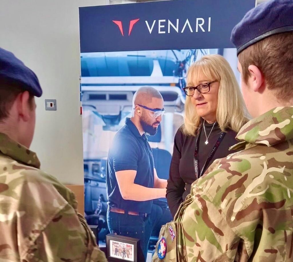 A woman talking to two army cadets with their backs to the camera at the RFCA careers fair