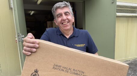 Man with box in front of store