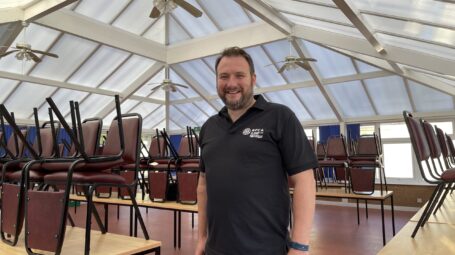 man in a conservatory with large expanse of roof