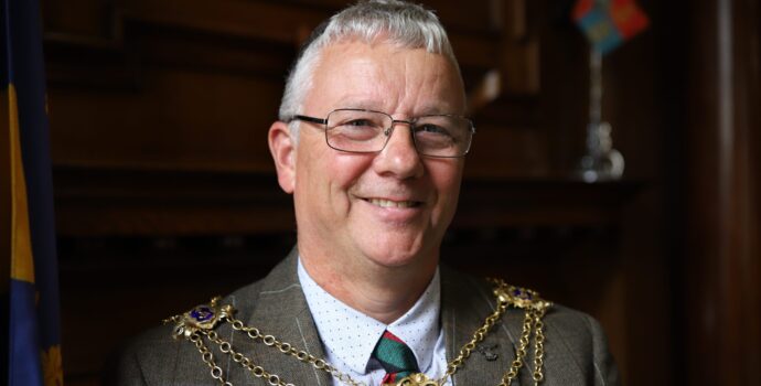 Man with glasses smiling at the camera