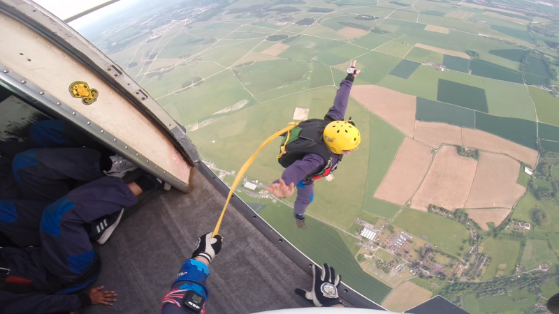 View from an aircraft of a man parachute jumping out of the air craft