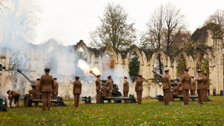 soldiers in the act of firing the gun carriages