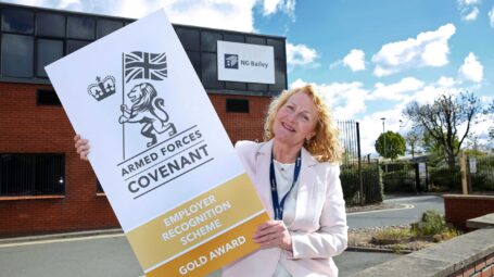 Woman holding Gold Award placard
