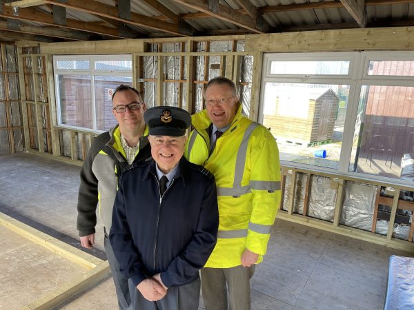 Three men, one in Air Cadet Volunteer uniform, one in high-visibility jacket in room that has been gutted ready for upgrade