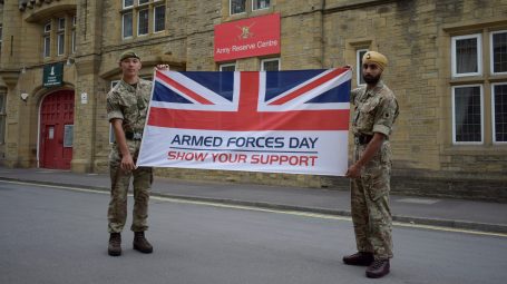 Two reserves hold Armed Forces Week flag