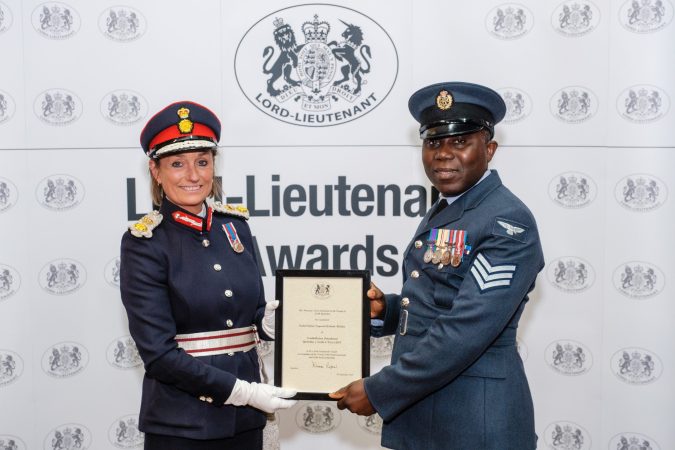 Woman Lord Lieutenant presents male reserve with certificate