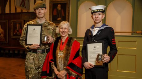 An army cadet and sea cadet pictured with their tankard awards with the Governor of the Merchant Adventurers in the centrecentre