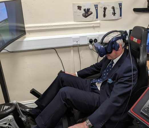 Man seated with a virtual reality headset on