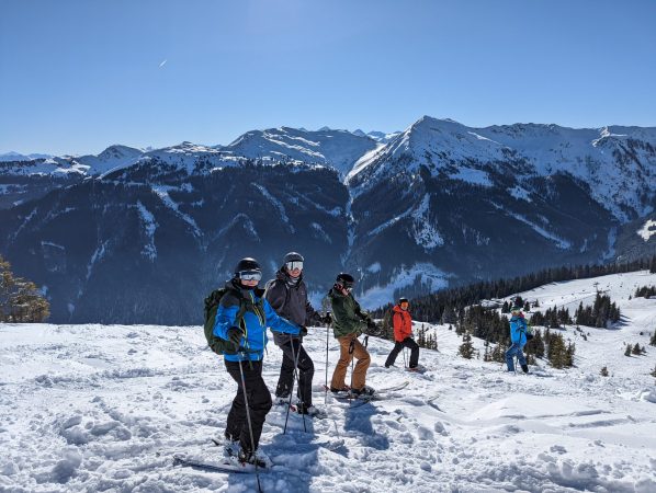 4 people with ski's on the slopes in Austria