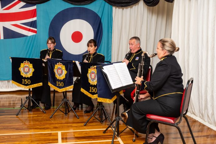 musicians in uniform seated playing their instruments