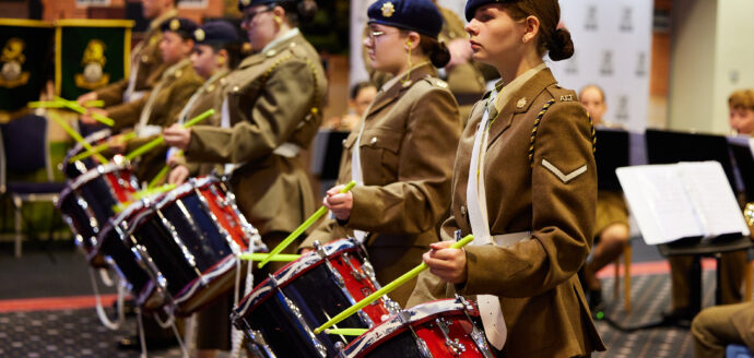 young people dressed in army cadet uniform playing drums