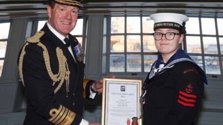 Admiral Ben Key hands Chloe Joyce-Richardson her certificate