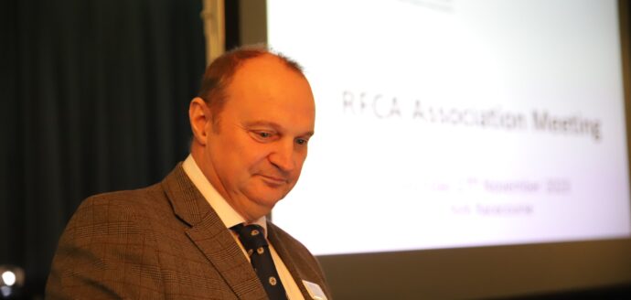 David Rhodes at a podium with a screen in background that says RFCA YH Association Meeting