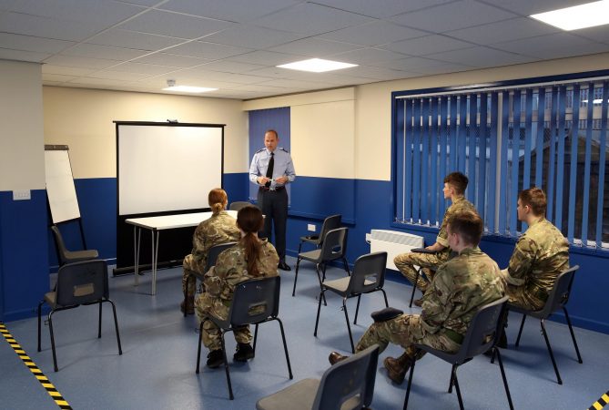 Cadets in classroom in front of white board with volunteer addressing them